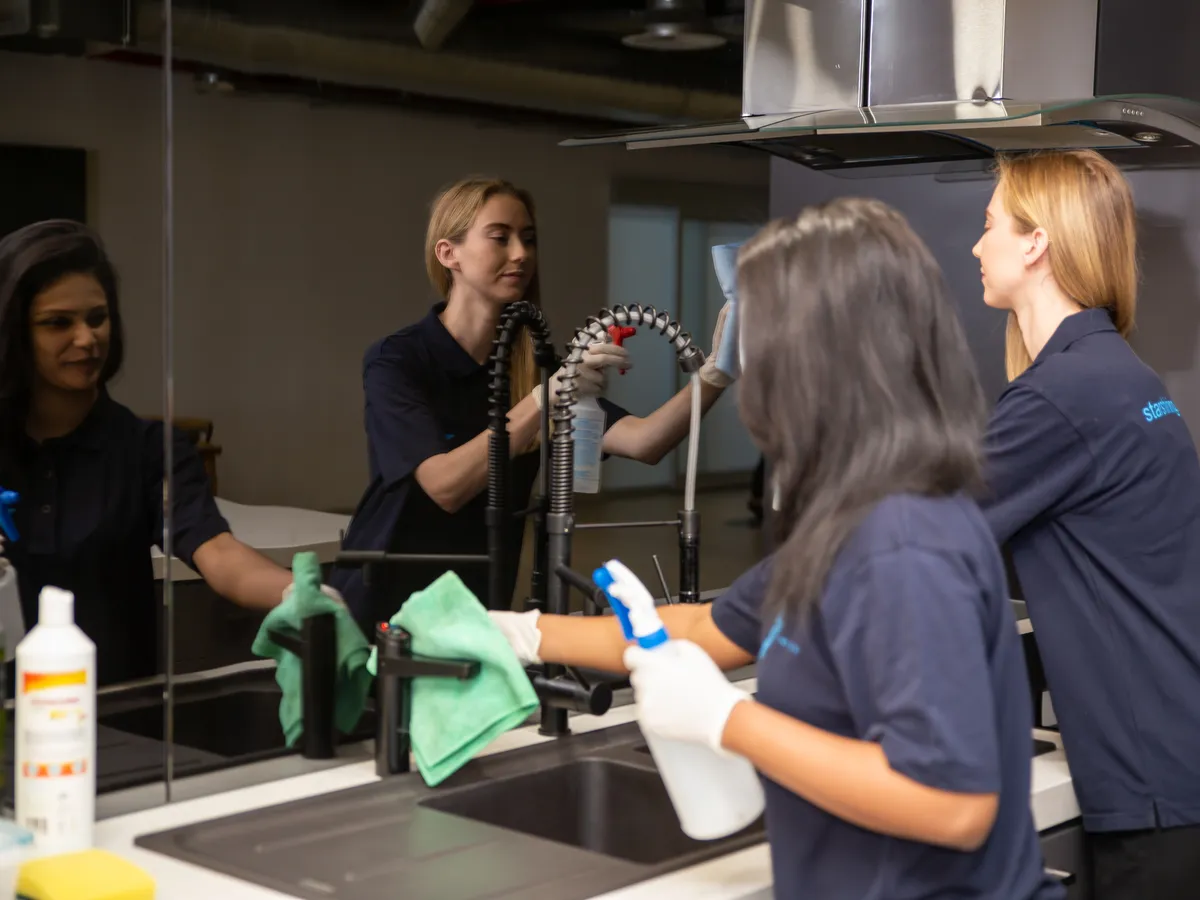 Star Shining cleaners wiping down a commercial kitchen bench